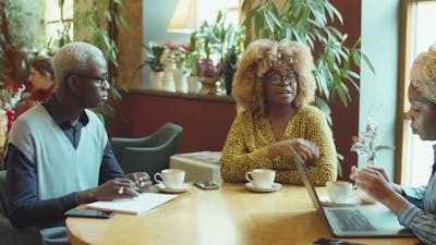 African American Business People Working in Cafe.