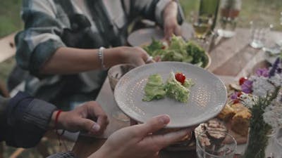 Serving Food to Guest at Picnic.