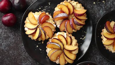 Homemade Mini Tarts with Fresh Sliced Plum Fruit.