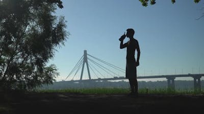 Sportman with Drink at the Open Air.