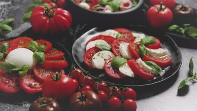 Salads with Traditional Italian Burrata and Mozzarella Cheese with Arugula and Tomatoes.