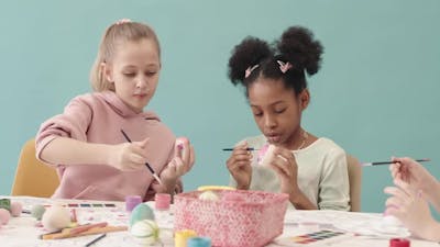 Diverse Children Coloring Easter Eggs.