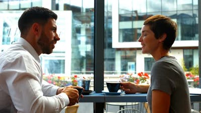 Businesspeople interacting while having coffee.