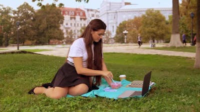 Student Eating Lunch in Park.