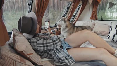 Female Tourist Taking Photo of Dog in Camper.