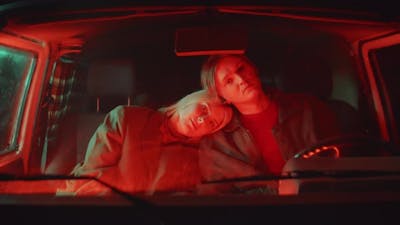 Portrait of Romantic Couple in Car with Red Light.