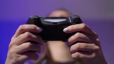 A Young Woman is Playing a Game Console.
