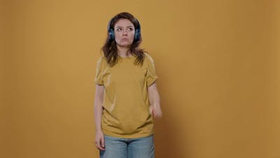 Woman Using Wireless Headphones to Stream Music Hearing Song for the First Time Giving Thumbs Up.