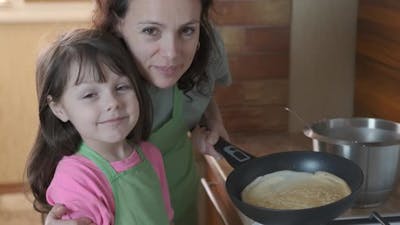 The family makes pancakes. .