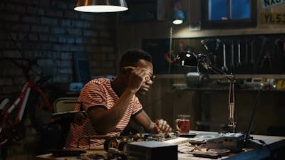 Man Repairing a Mother Board.