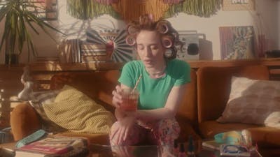 Girl in Curlers Drinking in 80s.