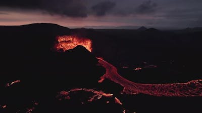 Active volcano emitting smoke and lava.