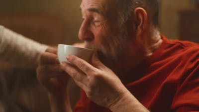 Elderly Couple Drinking Tea and Talking.