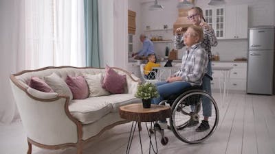 Loving Teen Granddaughter Combing Disabled Granny.