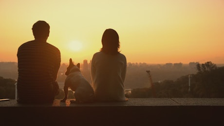 A couple in love watching a romantic sunset.