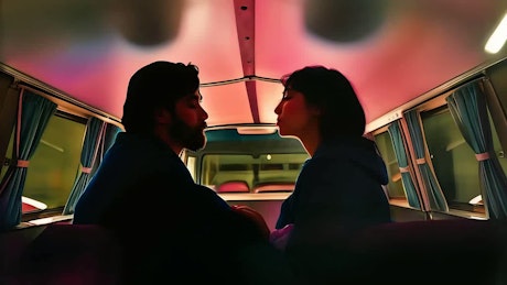 A young couple share a lovely kiss inside a vintage van.