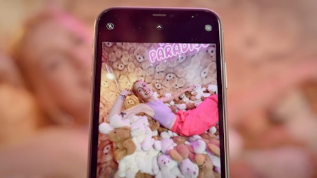 A young woman having fun in a teddy bear-themed room.