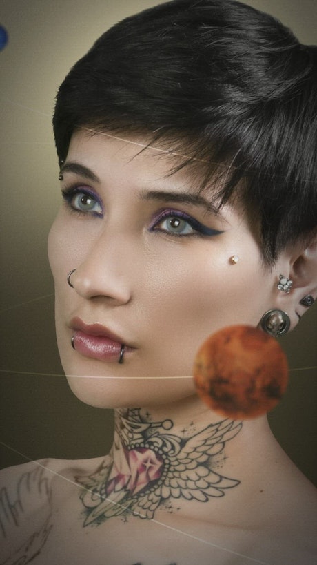 Animated photograph of planets orbiting a woman.