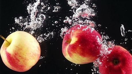 Apples falling through water.