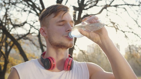 Athlete man drinking water in his training.
