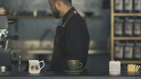 Barista cleaning a coffee machine.