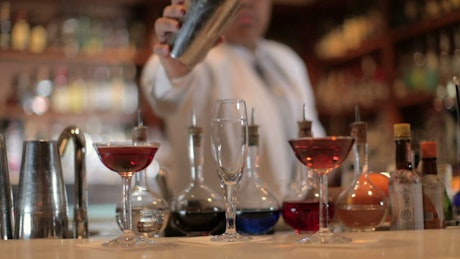 Barmaid preparing a cocktail in the bar.