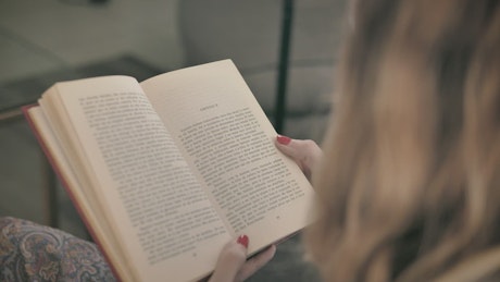 Blonde woman reading a book.
