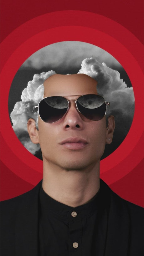 Conceptual image of a man with glasses and hair with sky clouds.