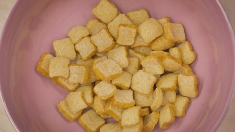 Corn flakes cereal texture in bowl with milk.