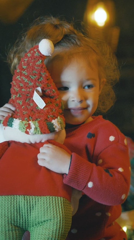 Excited girl with a stuffed Santa Claus.