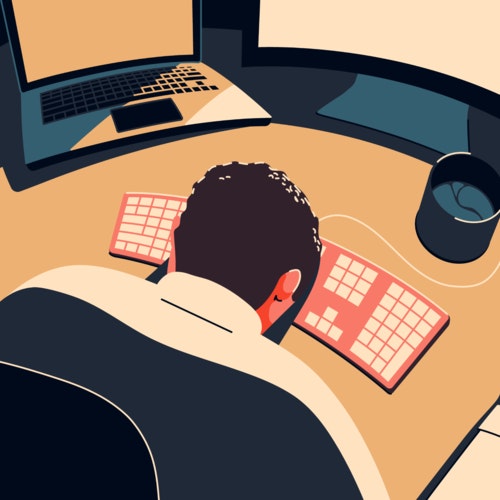 Exhausted man in front of a computer, with his head down on a desk