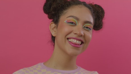 Face of a charismatic woman eating a glazed donut.