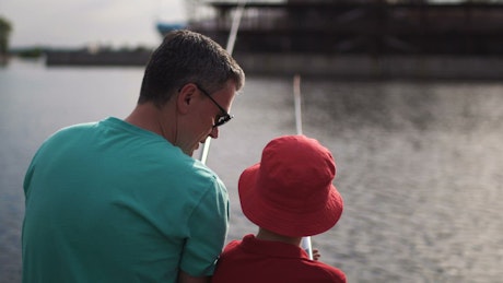 Father and son fishing in the river.