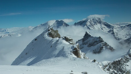 Fog on the heights of the snowy mountains.