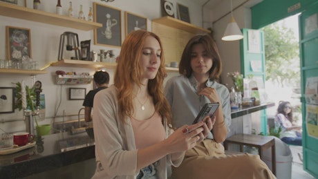 Friends taking a selfie in the cafe.