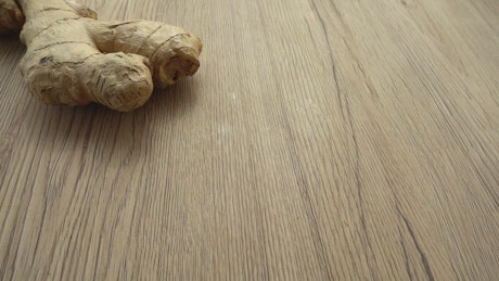 Ginger slices falling on the table.