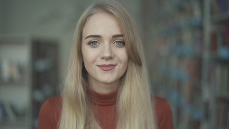 Girl smiling, portrait in the library.