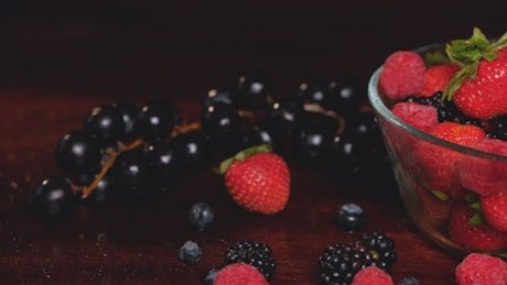 Glass bowl full of red berries seen in detail.