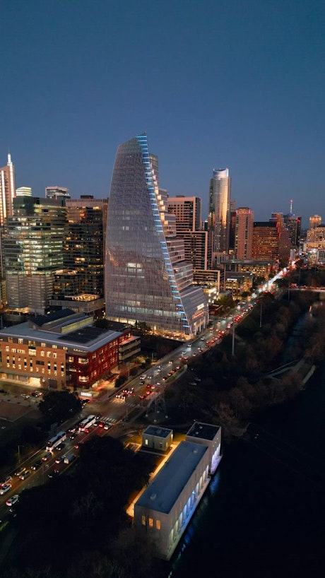 Huge city with a river in an aerial view at dusk.