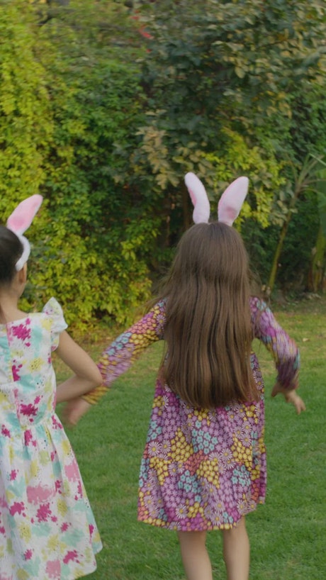 Little girl finds an easter egg in the garden.