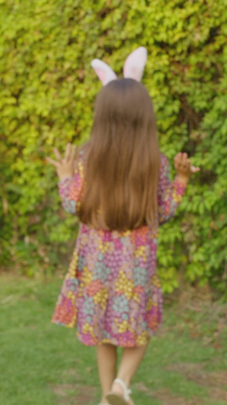 Little girls looking for eastern eggs in the garden.