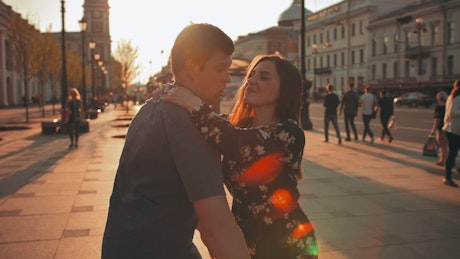 Man carrying his girlfriend in the city.