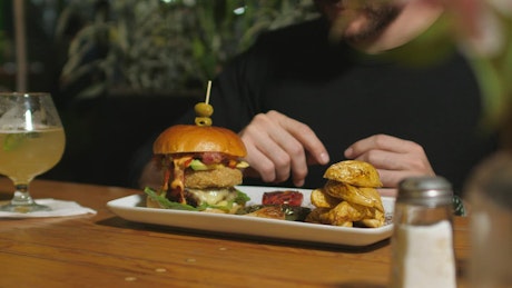 Man eating a hamburger.