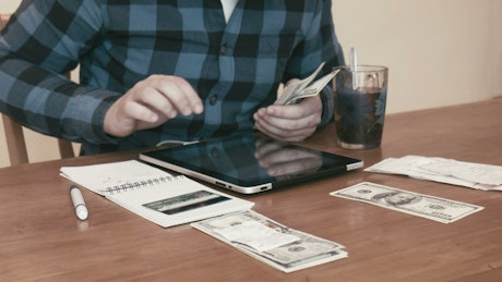 Man separating money for different budgets.