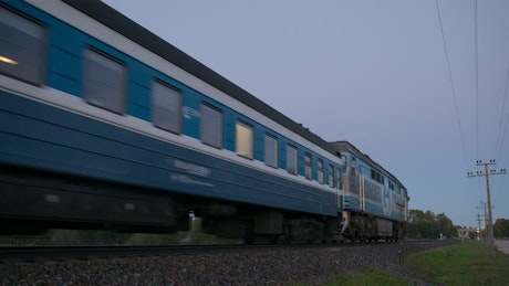 Passenger train passing by slowly.