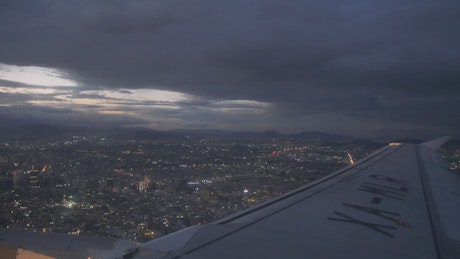 Plane flying over a city at night.