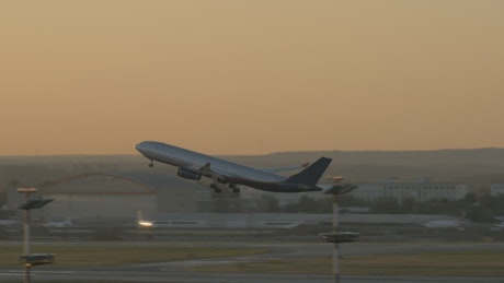 Plane taking off at dusk.