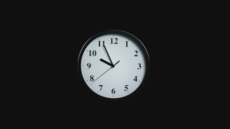 Slowly approaching a clock on a black background.