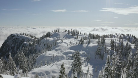 Snowy hills with clouds.