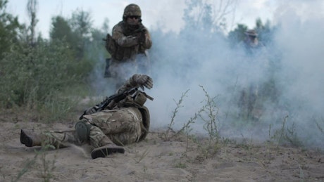 Soldier getting shot on the battlefield.